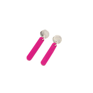 silver earrings with pink dangling long and thin shape below. Photographed laid flat against a white background 
