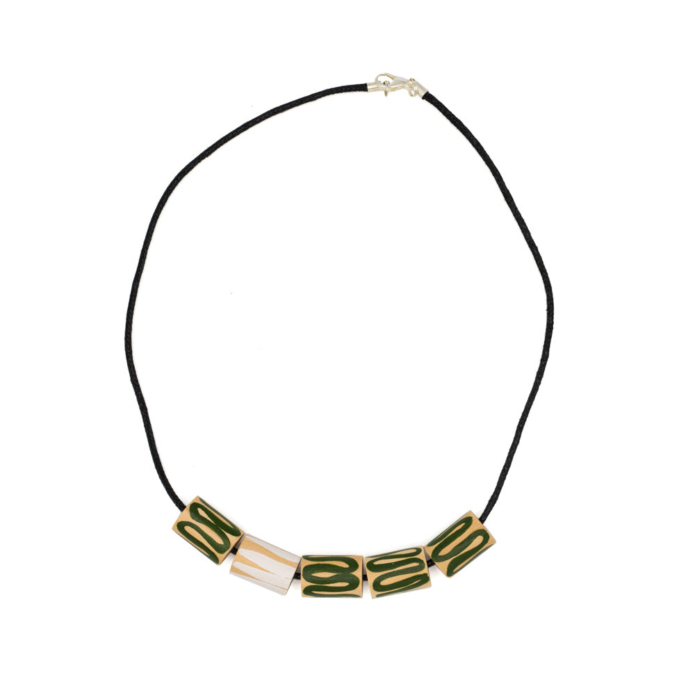 Necklace with thread chain against white background. Circular shapes threaded through the necklace mad eof wood, hand-painted with green and white swirls.
