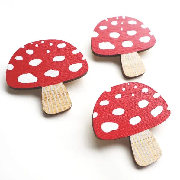 Three wooden hand-painted toadstool brooches.