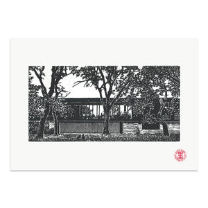 Photo of an artist print of the Whitworth Cafe surrounded by Trees. Black and white lino print on  paper
