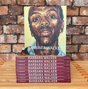 A stack of catalogues with one stood upright above. The catalogue features Barbara Walker's Pride, a portrait of a young man. Photographed in front of a brick wall.