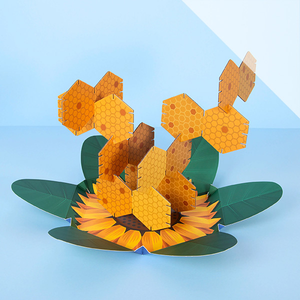 A cardboard puzzle game fitted togethter in the shape of a beehive with a blue background