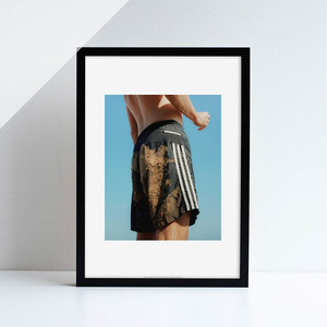 A printed reproduction of a photograph by Megan Dalton featuring a person in football shorts.