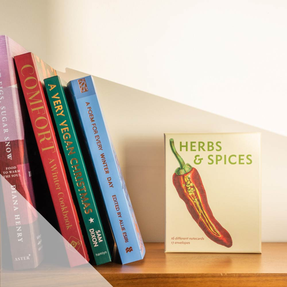 A selection of books stacked on a bookshelf