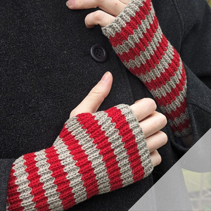 Image of a person wearing red and grey striped fingerless gloves