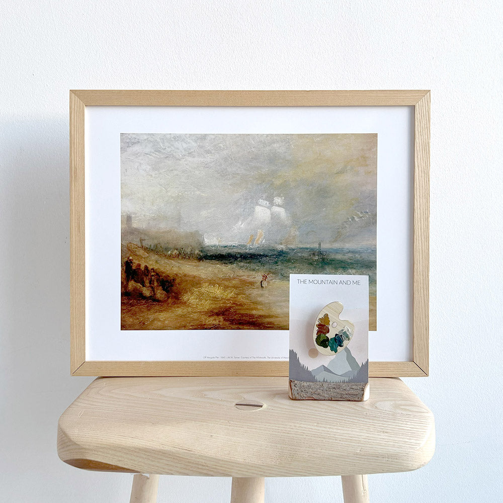 A framed reproduction of a Turner painting on a stool