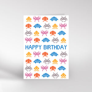 Birthday card with pixelated space invaders design and 'Happy Birthday' text on a white background.