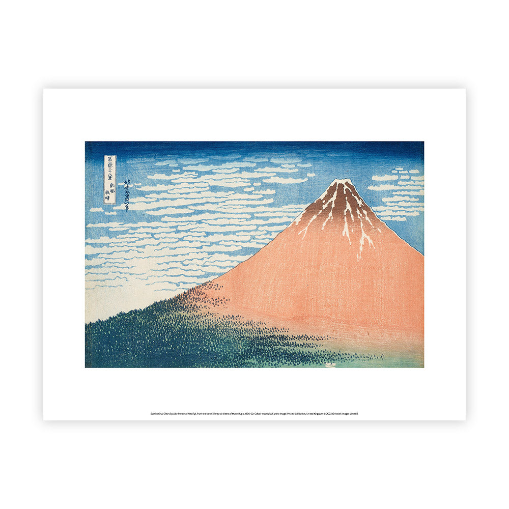 Framed artwork of Mount Fuji with a blue sky and white clouds.