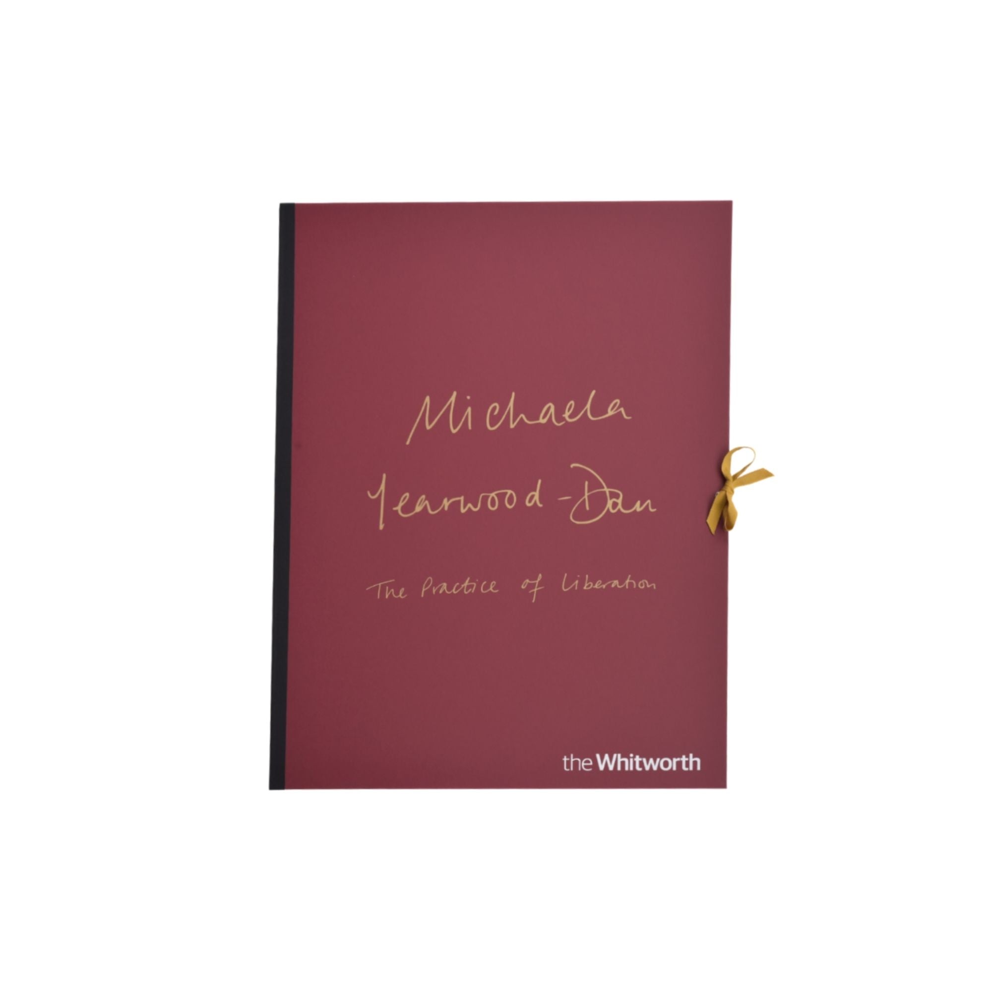 Limited Edition folio in a deep burgundy red, featuring gold foil script text reading 'Michaela Learwood-Dan' and 'The Practice of Liberal Arts', with 'the Whitworth' printed in white at the bottom right and a small gold ribbon tied to the side.