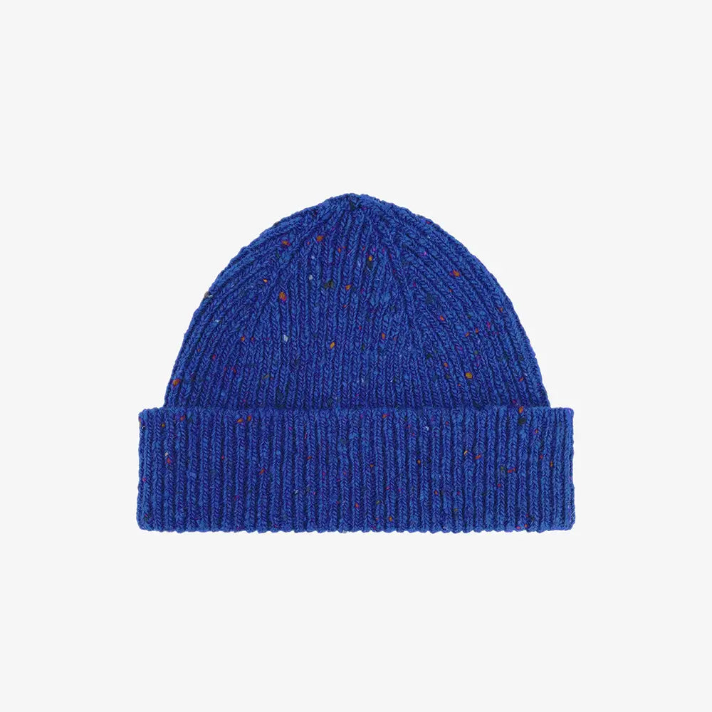 Blue knit beanie on a light gray background
