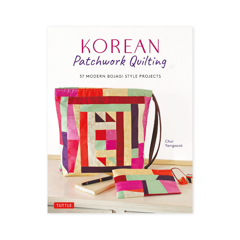 Book cover featuring a bag made out of patchwork quilt at the centre