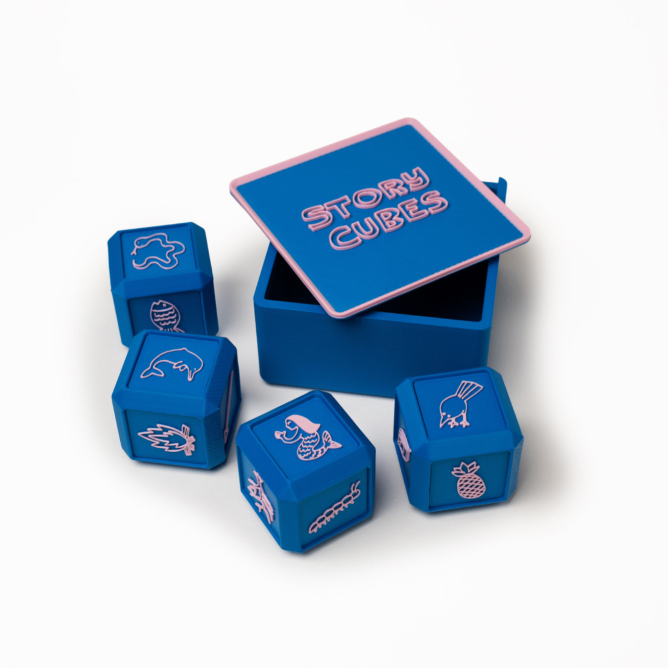 Blue cubes with different pictures embellished on them. Photographed against a white background.