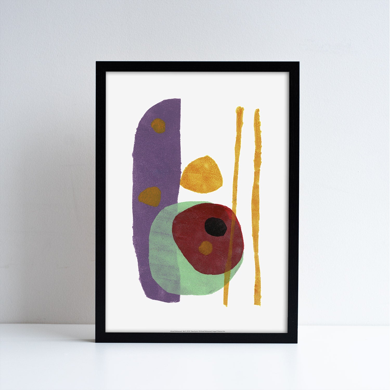 Reproduction of an abstract artwork by Ahmed Mohammed. Full of abstract shapes in multi colours. Inside a black frame.