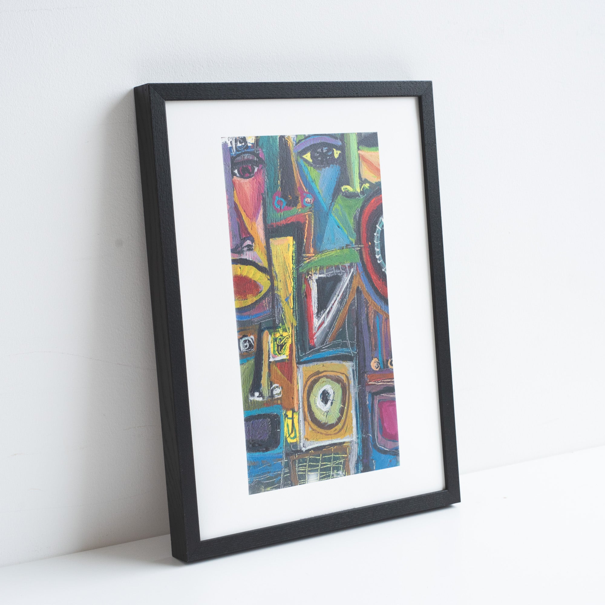 Print of an abstract painting by Akinyemi Oludeli. Placed in a black frame leaning against a white wall.