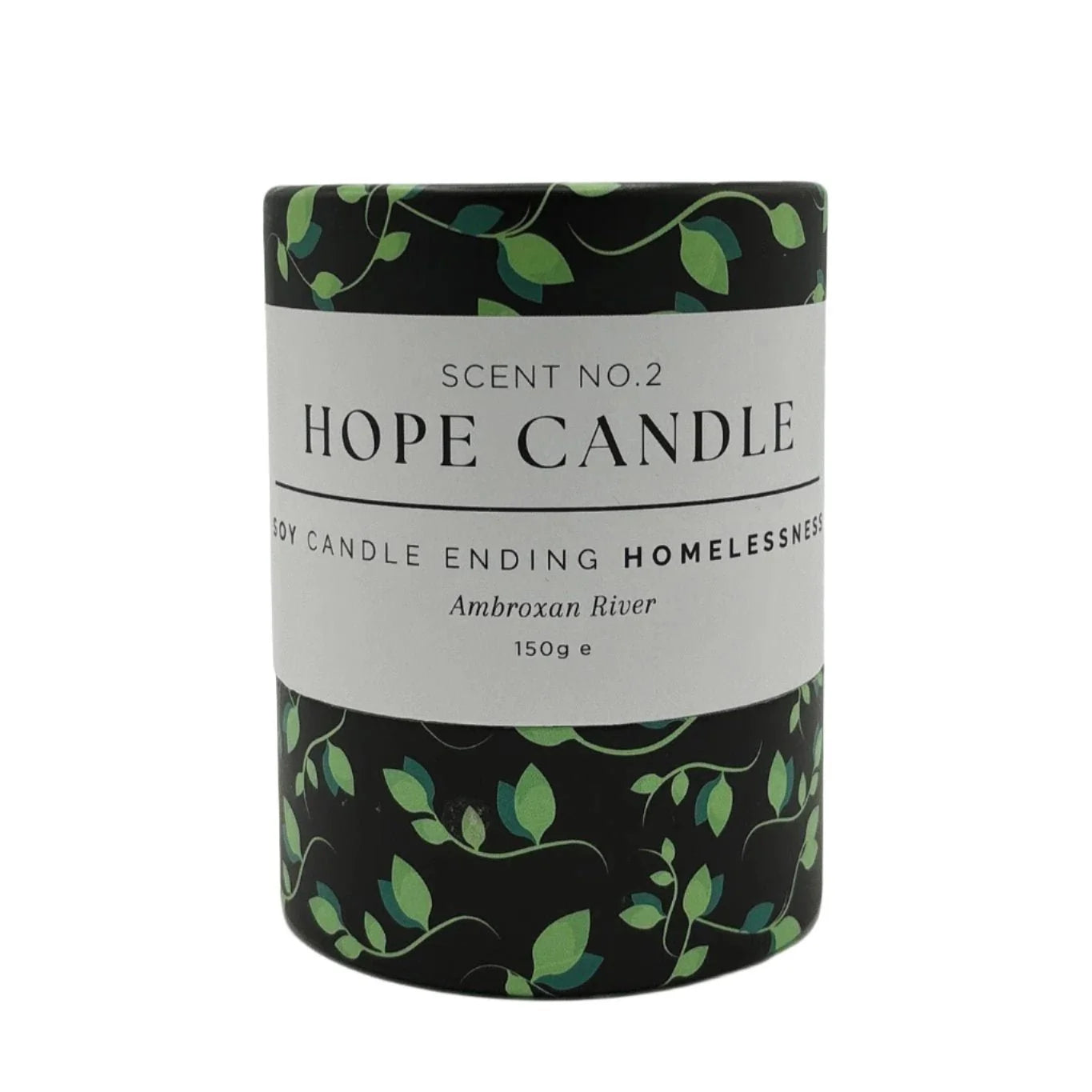 A black cylindrical candle container with a white label featuring green vines sits on a white background.