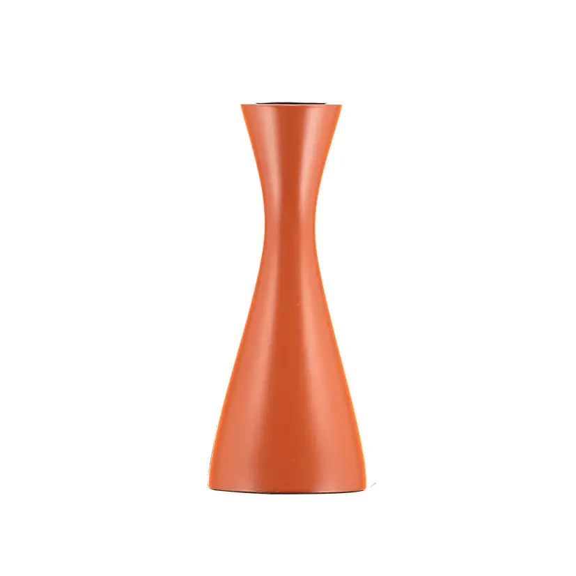 Cylindrical orange candle holder on a white background