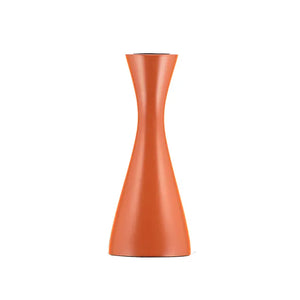 Cylindrical orange candle holder on a white background