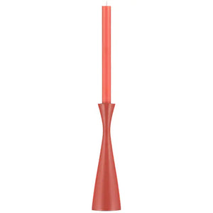 Red candle in a matching red holder on a white background