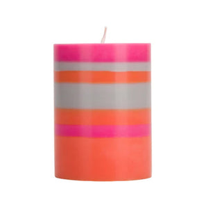 Pink, orange and grey striped candle in cylinder shape