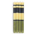 Set of six striped candles with black and yellow bands on a white background