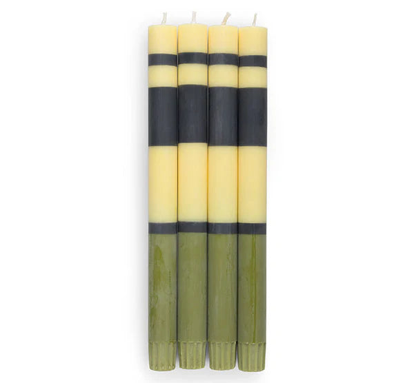 Set of six striped candles with black and yellow bands on a white background