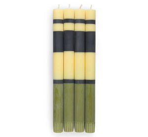Set of six striped candles with black and yellow bands on a white background