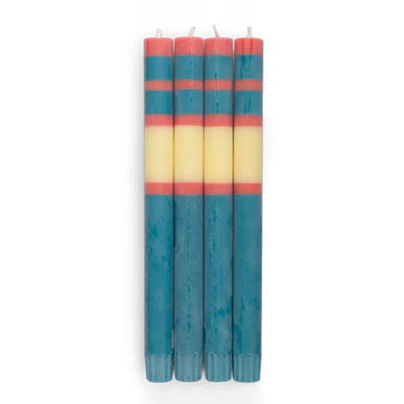 A set of four blue, yellow and pink striped taper candles.