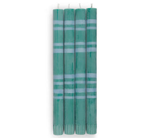 Set of four green candles with white stripes on a white background
