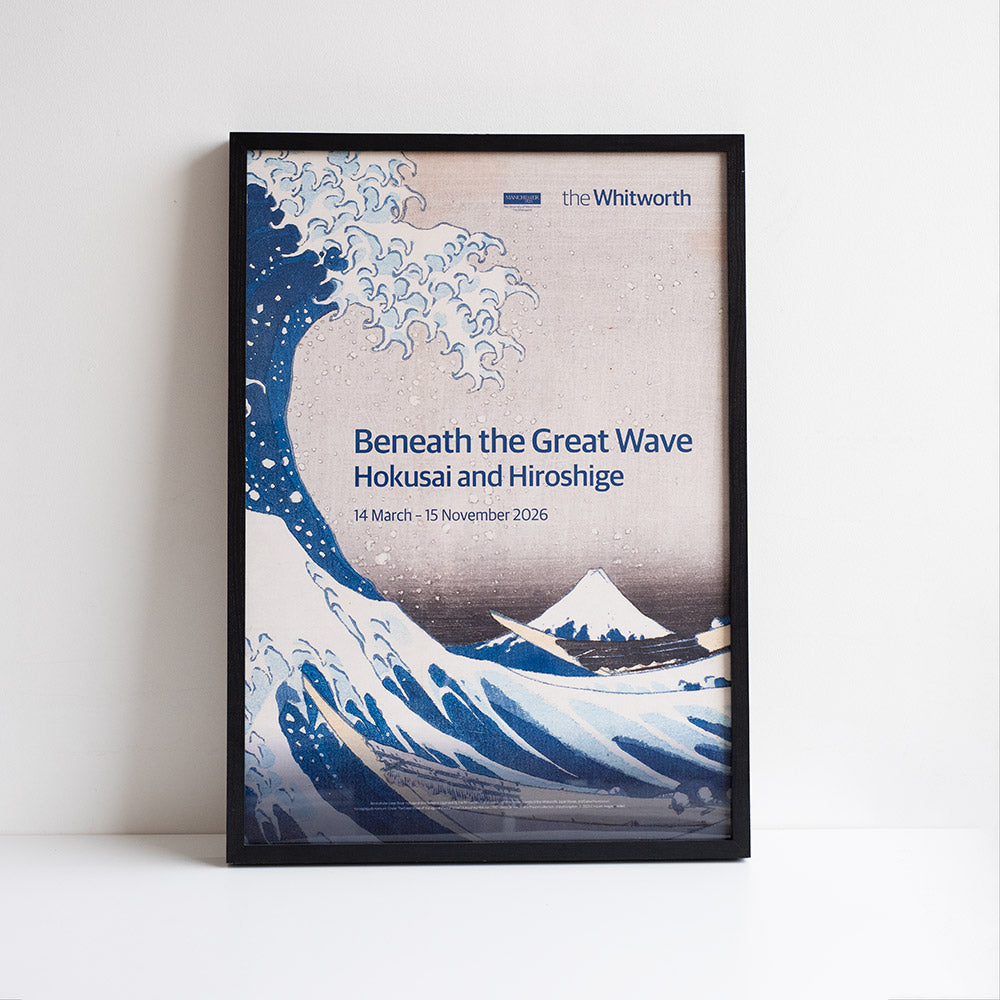 Framed poster for 'Beneath the Great Wave' exhibition at the Whitworth with wave design and text.
