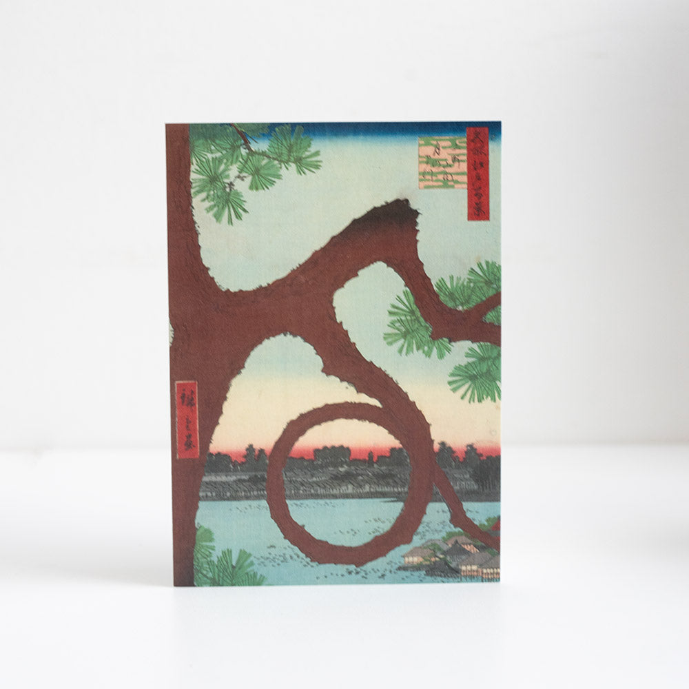 Greetings card of a traditional Japanese woodblock design of a tree and sunset.