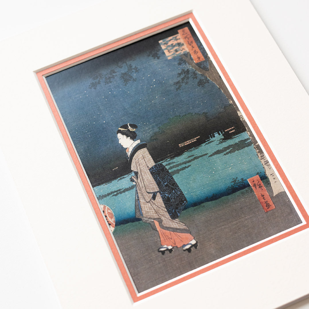 Cropped detail of mounted artwork of a traditional Japanese scene with a person in a kimono on a light grey background