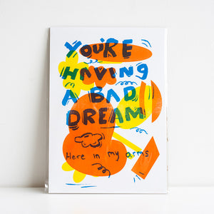 Colorful poster with text 'You're Having a Bad Dream Here in My Arms' on a white background