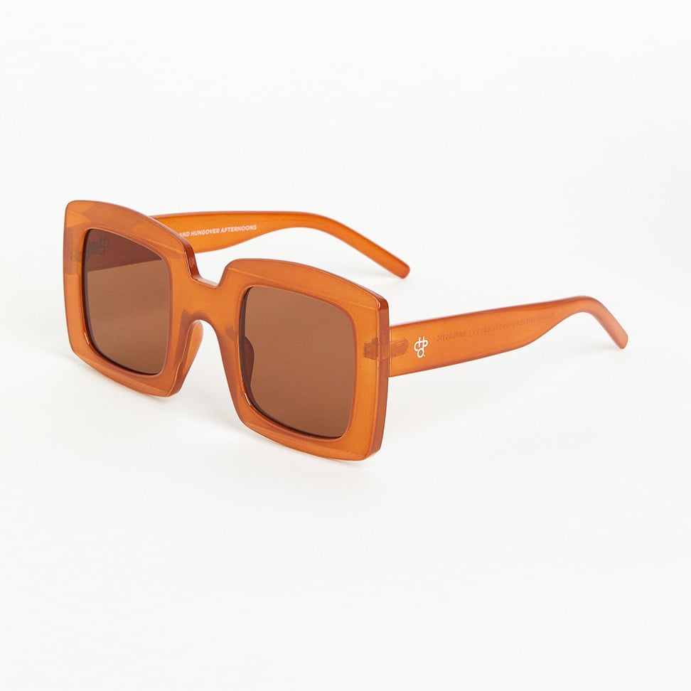Mustard sunglasses with a transparent frame on a white background