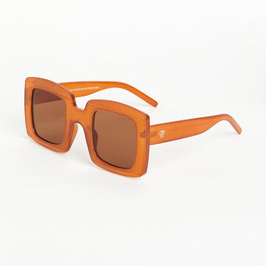 Mustard sunglasses with a transparent frame on a white background