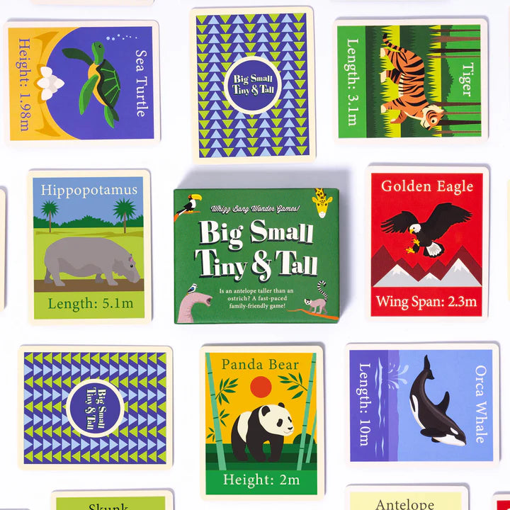 A spread of cards from a card game. The cards feature illustrations of different animals, including a sea turtle, a tiger, a hippopotamus, a golden eagle, a panda bear, an orca whale, a skunk, and an antelope. Each card also includes information about the animal's size, such as length, height, or wingspan. The game box is also visible in the centre of the image.