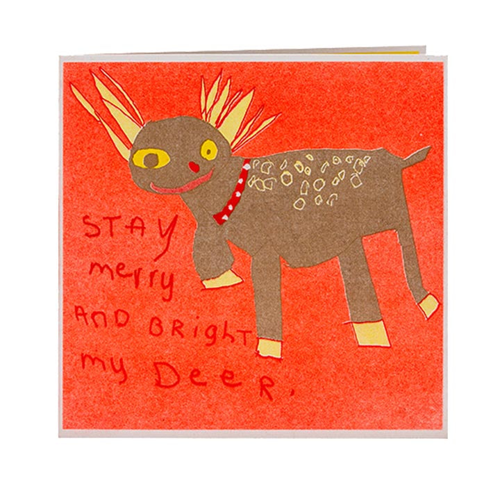 A greetings card against white background. The card has a drawing of a raindeer against red background.