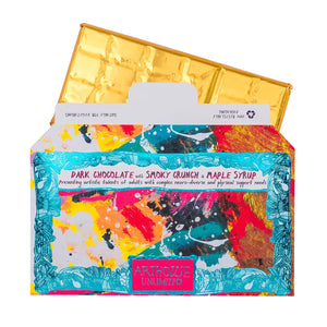 Bright and colourful rectangular packaging for a chocolate bar. With an arthouse unlimited artwork. You can see the chocolate come out of the packaging, which is wrapped in gold foil.