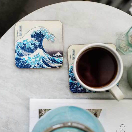 Table setting from above with Wave coasters and one with a mug of coffee on it