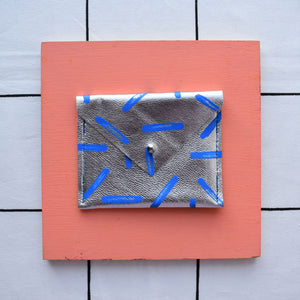 Silver metallic rectangular card pouch with hand painted design.