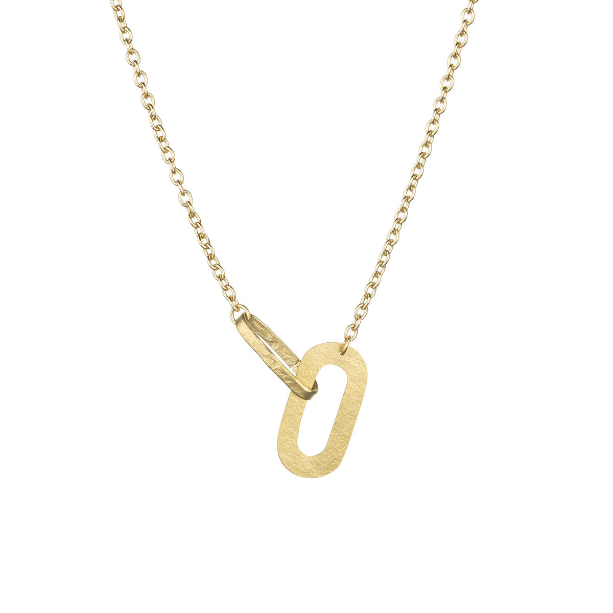 A gold necklace with a unique pendant. The pendant is an oval shape with a smaller oval attached to it.