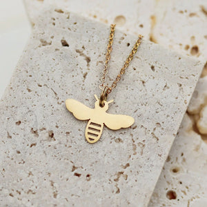 Gold chain necklace with pendant in the shape of a bee