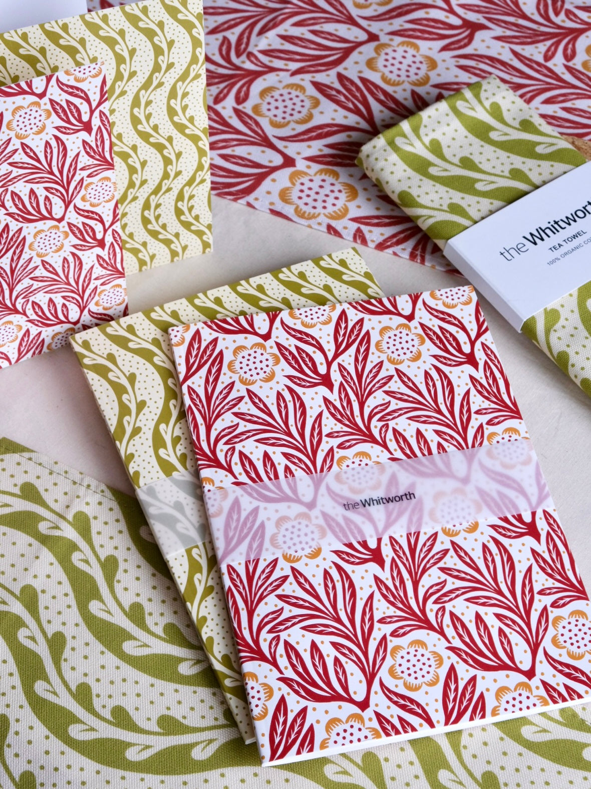 Patterned notebooks with visible branding on a white surface