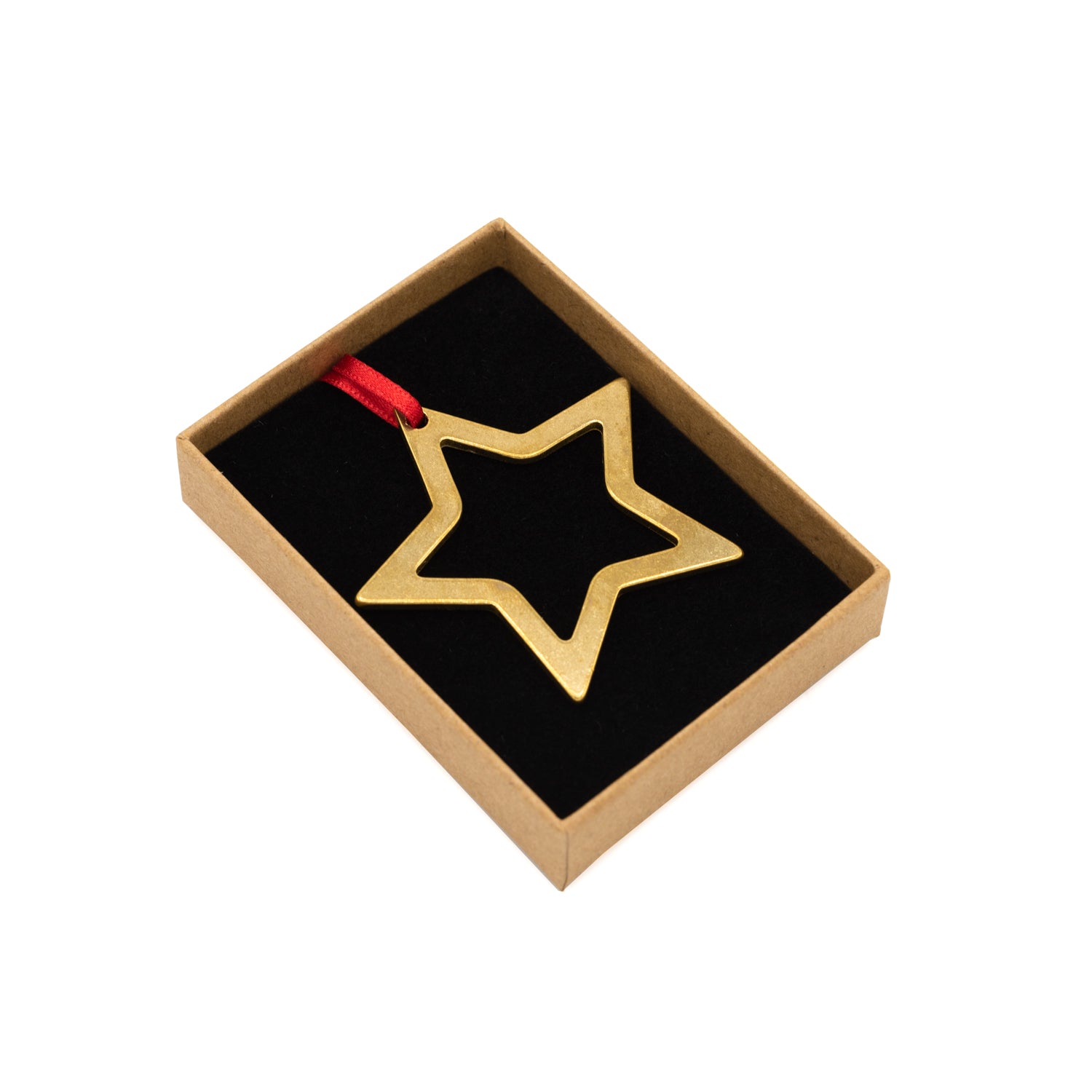 Brass star-shaped decoration with red ribbon. Photographed inside it's box against a white background.
