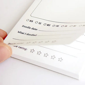 Hand holding a doodle date planner with star rating system