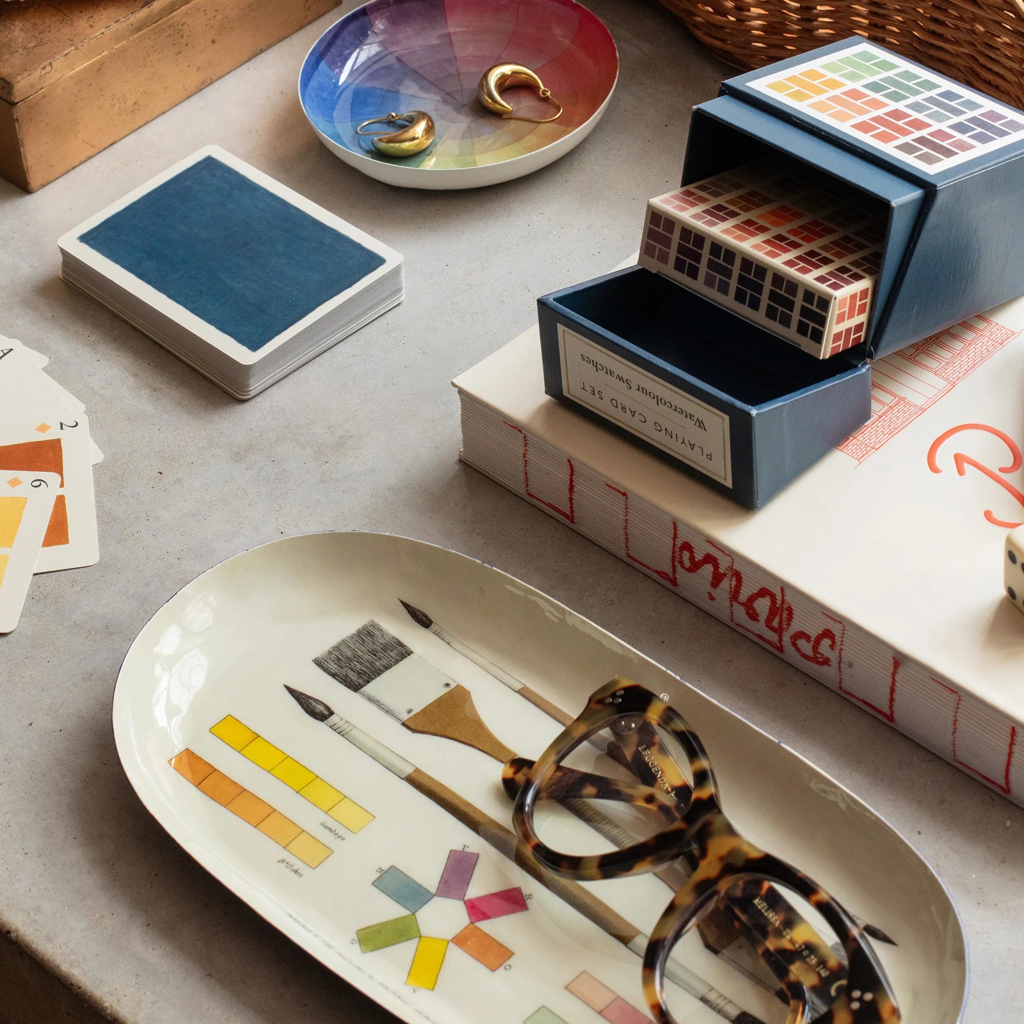 A flatlay showing a variety of items on a grey surface. Included are: