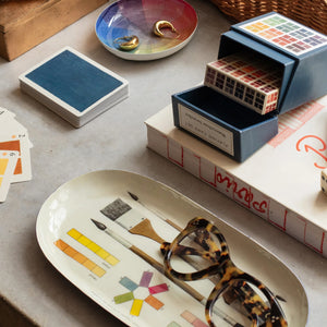 A flatlay showing a variety of items on a grey surface. Included are: