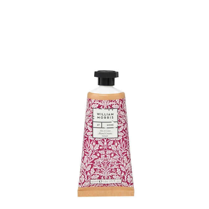 A tube of William Morris 'At Morn' hand cream, featuring a red and white damask pattern with a black cap, set against a plain white background.