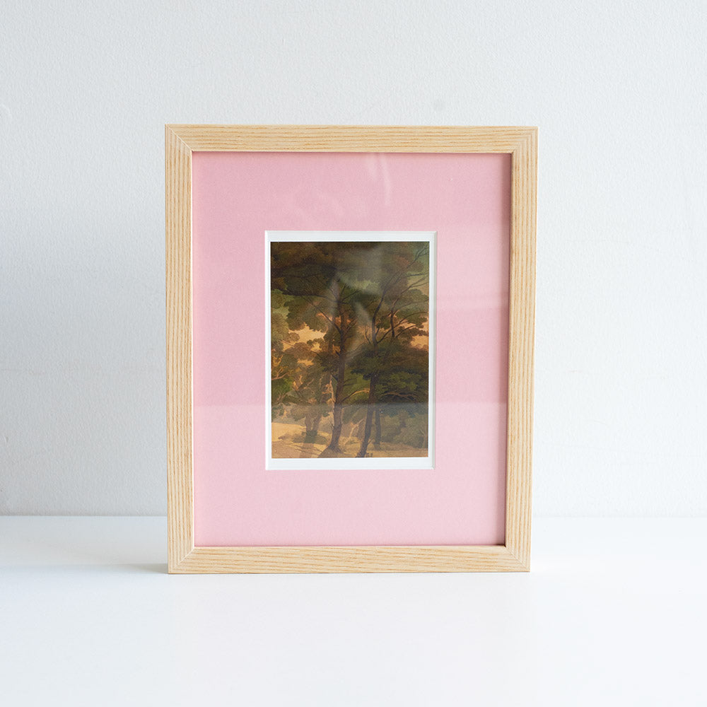 Framed postcard of a tree painting, with a pink mount against white backdrop