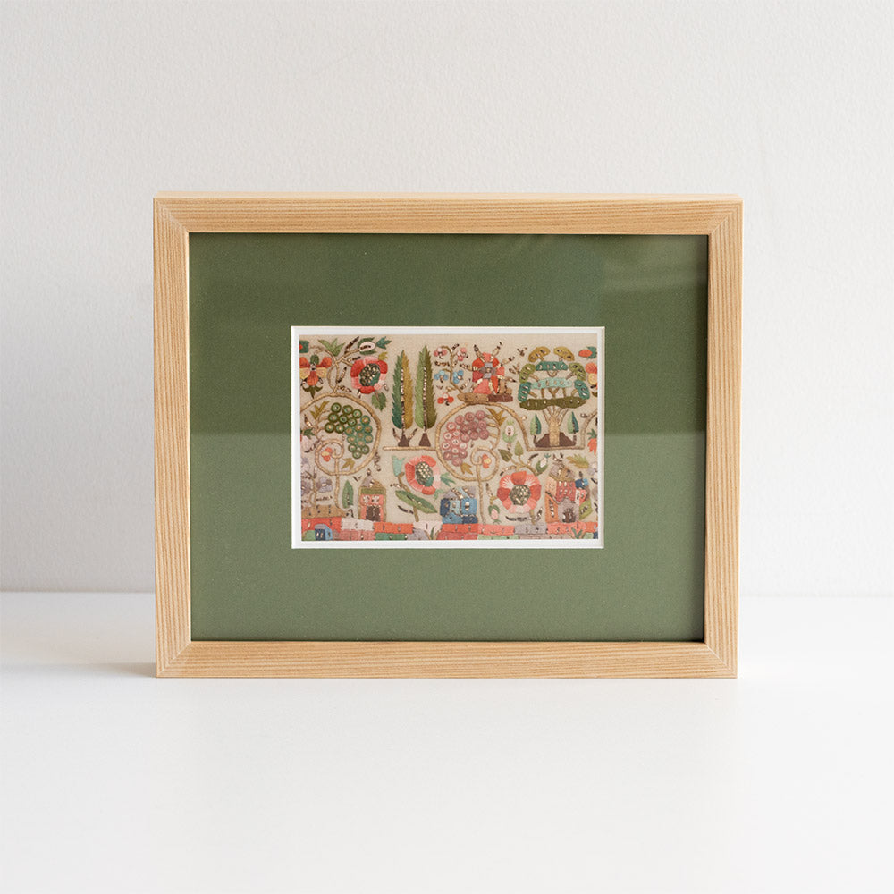 Framed artwork with a colourful design on a green background