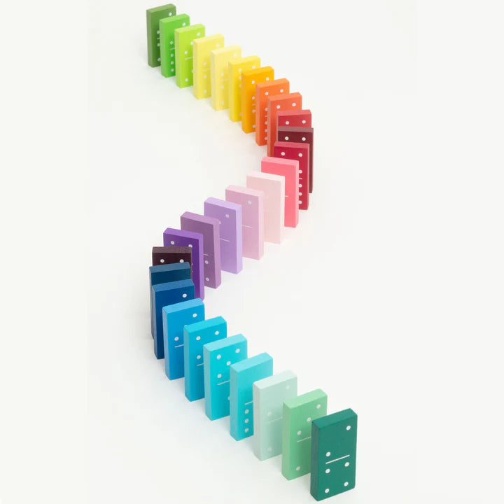 A curved line of colorful dominoes arranged in a rainbow gradient, from green to purple and back to green.